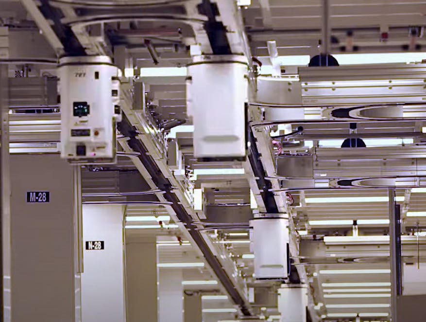 Overhead automated material handling system in a chip fab
