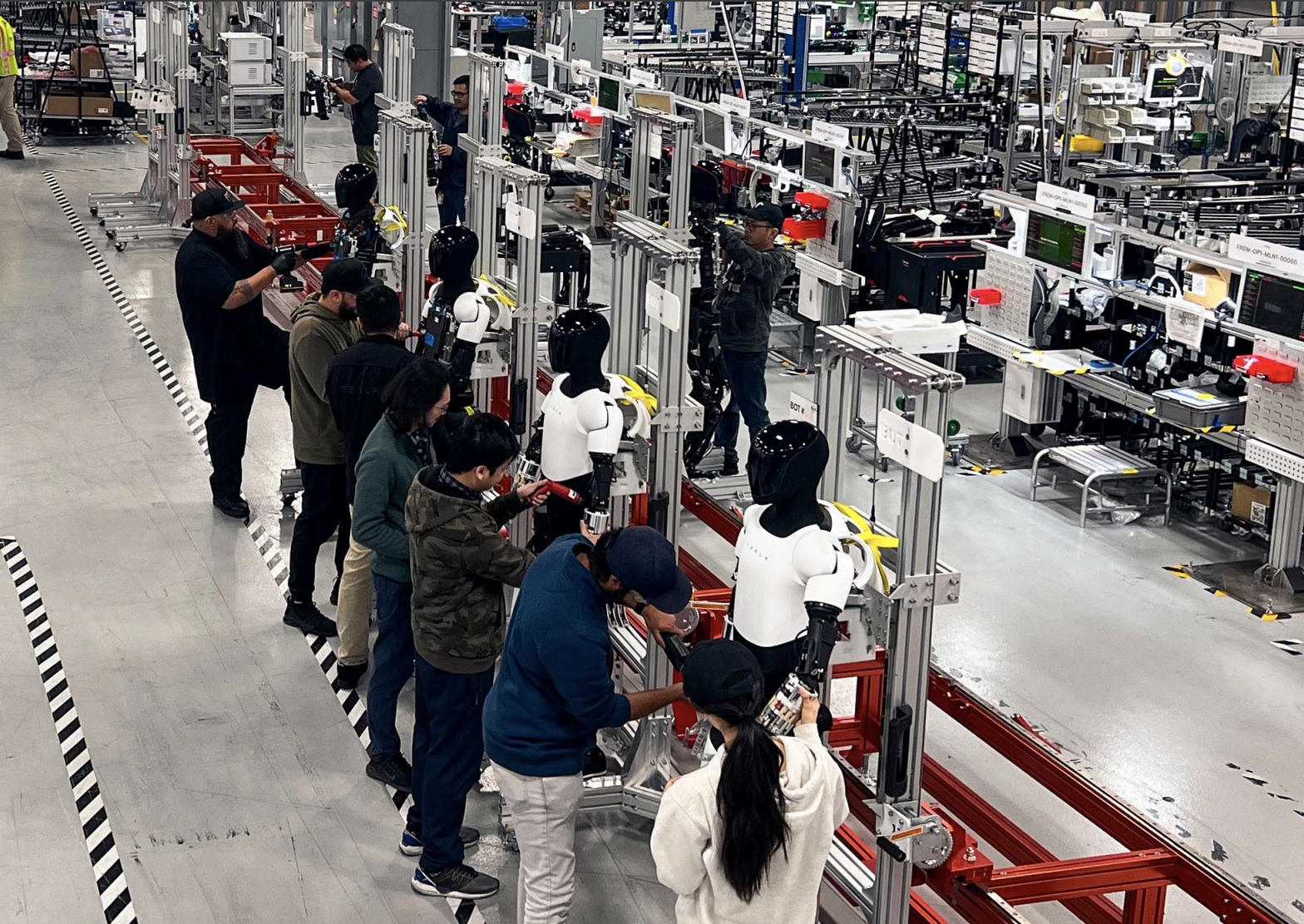 Tesla Optimus humanoid robots on the Fremont pilot line