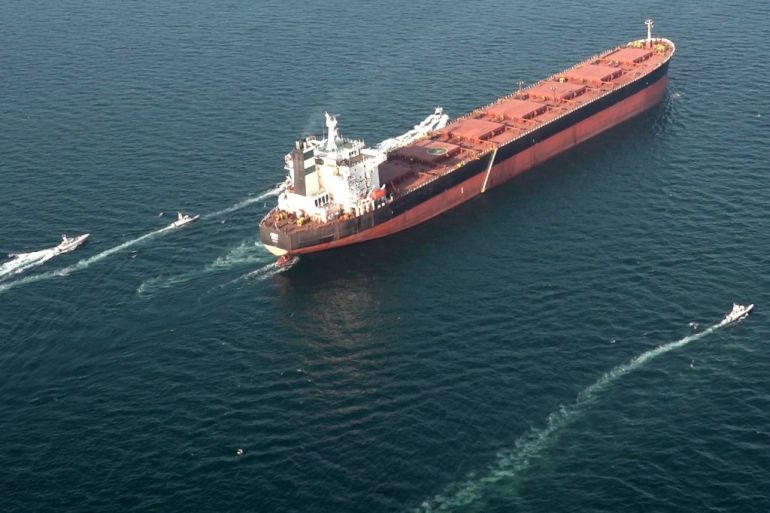 A very large crude carrier with escort craft in the Gulf